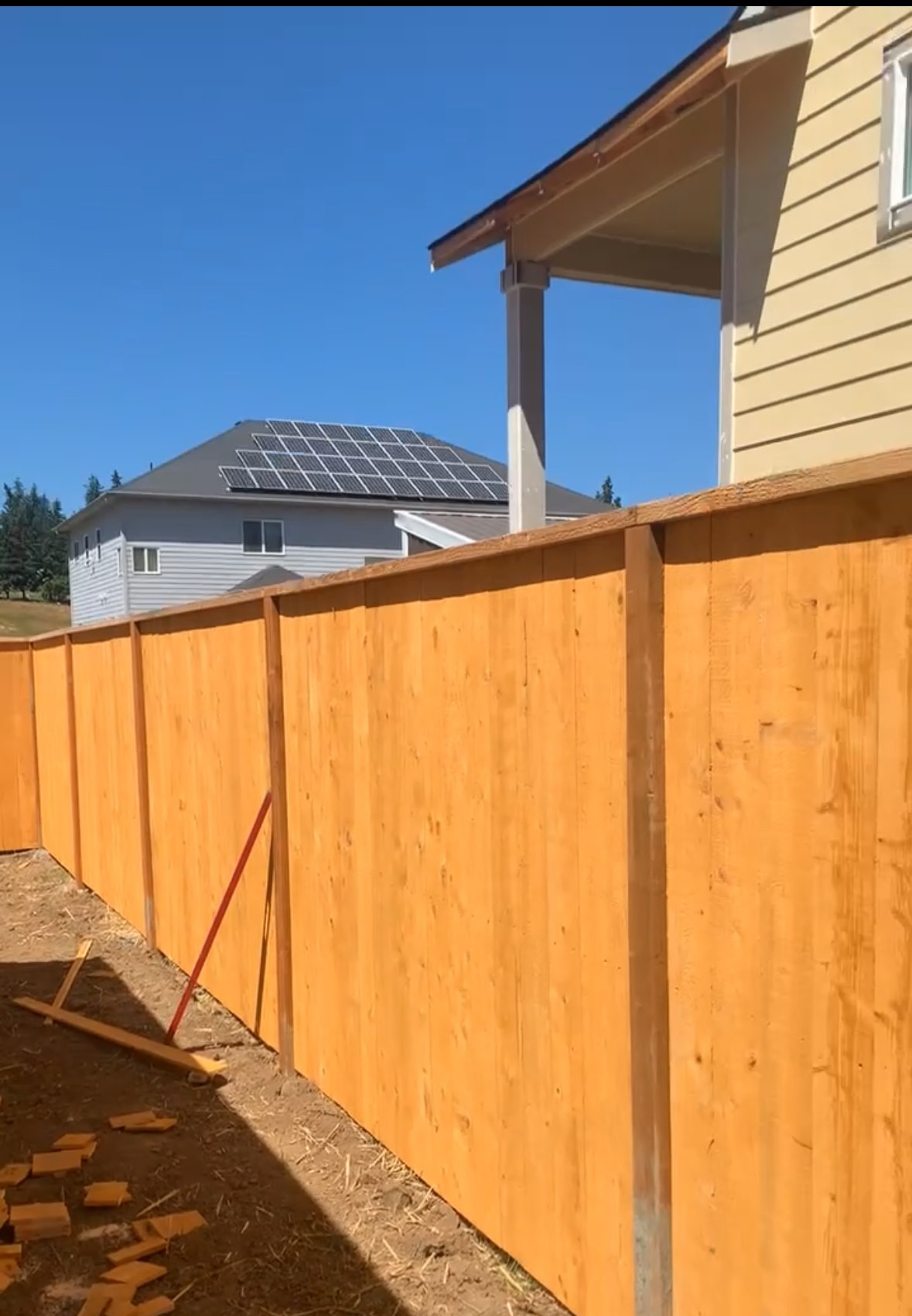 Close detail of cedar fence boards, posts and top cap