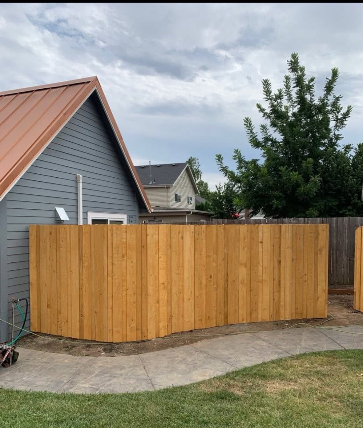 Finished cedar privacy fence along a Salem-area backyard, with clean posts and a level top line