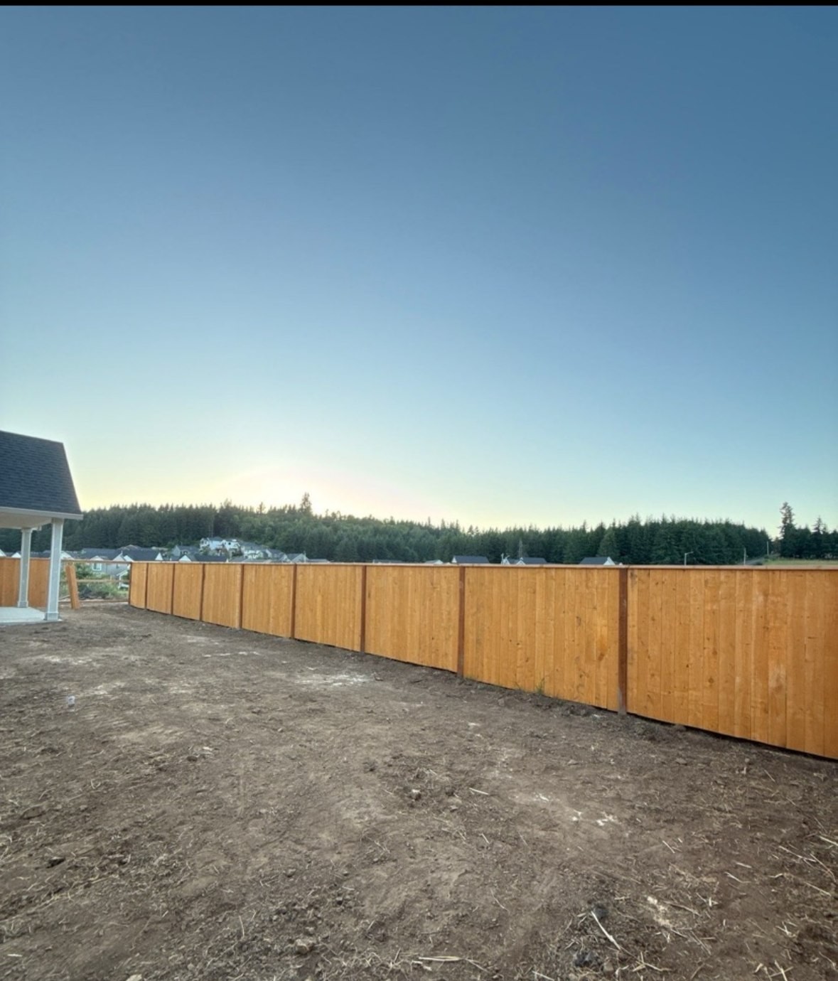 Extended cedar fence run along a property boundary